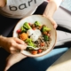 How to lose weight naturally, showing a person eating healthy food.
